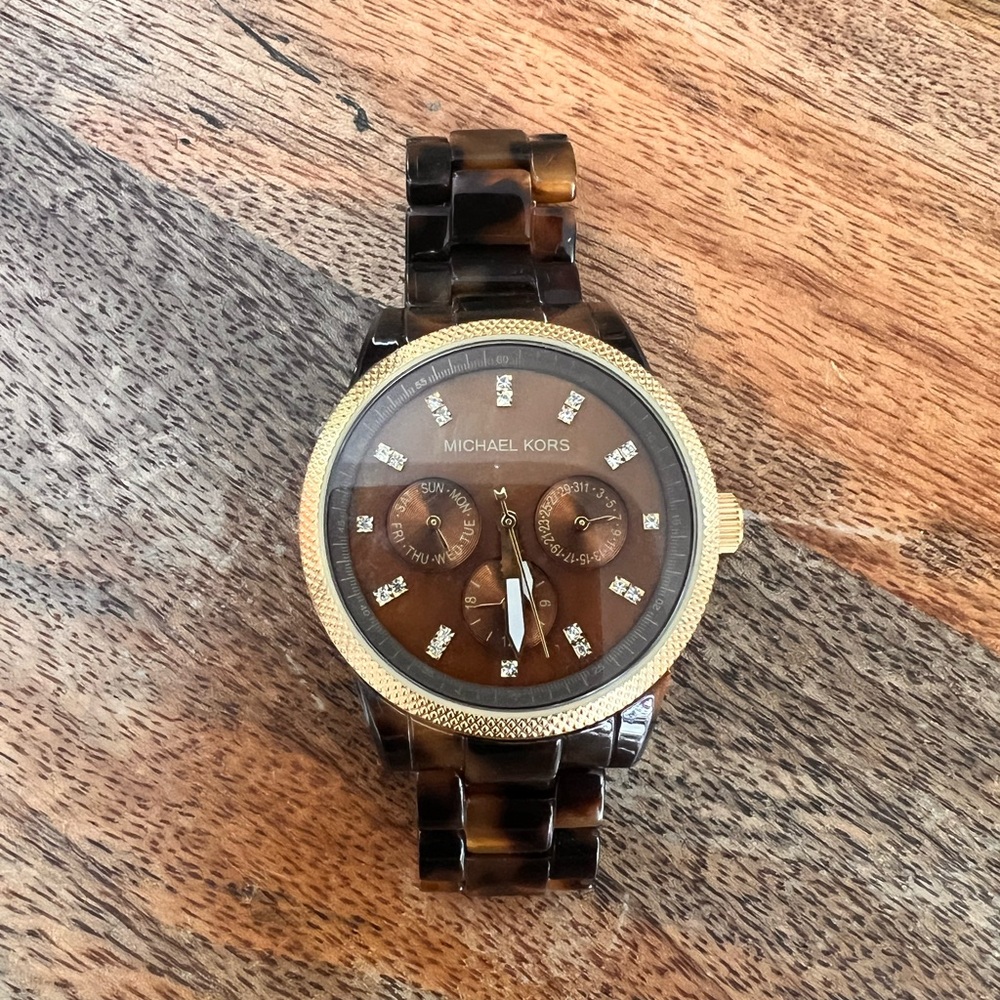 Michael Kors tortoise shell watch in gold.